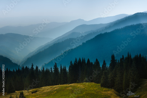 Majestic landscape of summer mountains. A view of the misty slopes of the mountains in the distance. Travel background. 