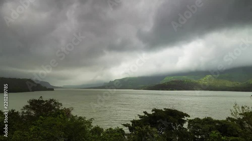 A monsoon storm is passing over the Mulshi dam, Maharashtra, India.  photo