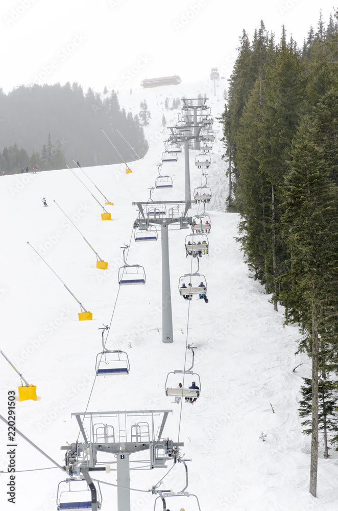 Fototapeta premium Skiers on a ski-lift