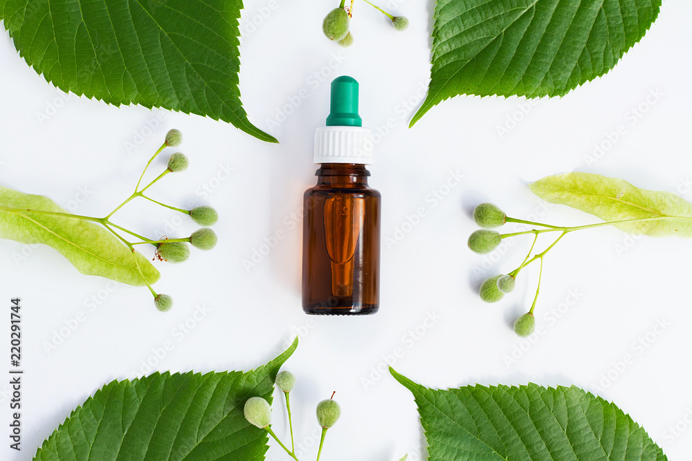 bottle with dispenser with green leaves and lime on a white background bottle with dispenser with green leaves and lime on a white background