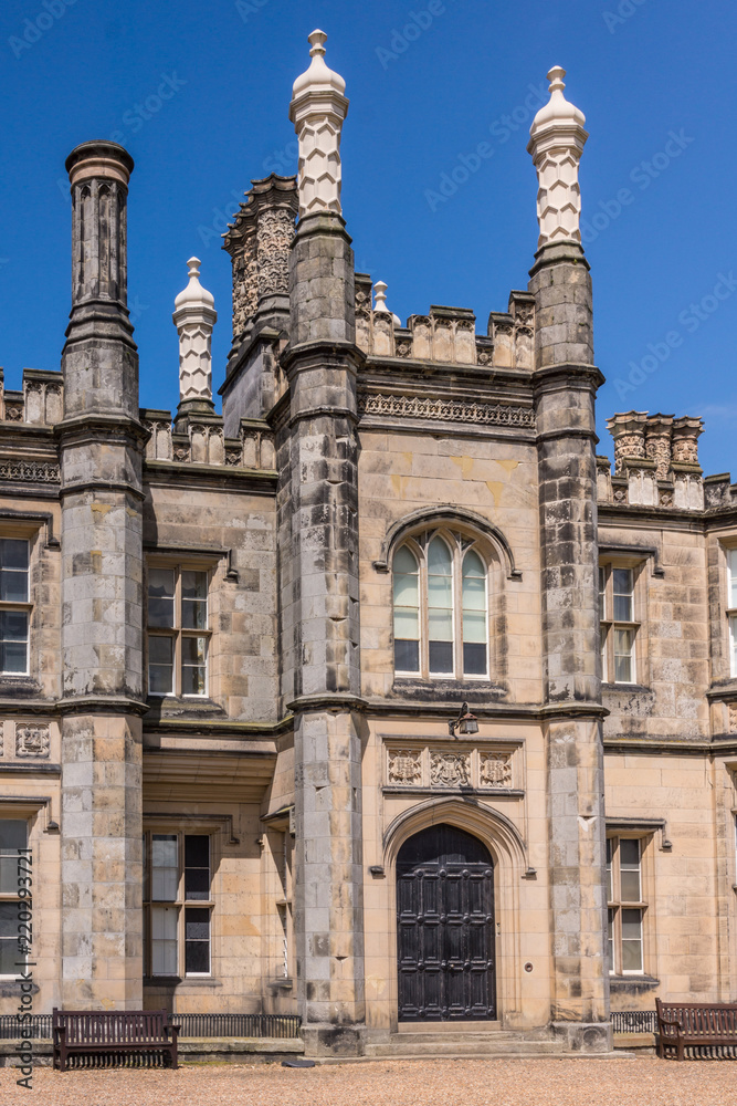 Edinburgh, Scotland, UK - June 14, 2012: Main entrance and tower of Dalmany house, mansion and castle in Tudor revival style. Blue sky.