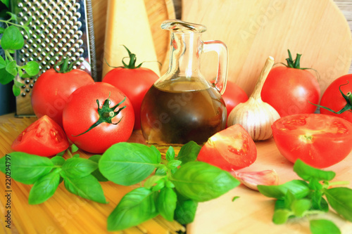 Italian cuisine products: tomatoes, olive oil, garlic, basil, cheese