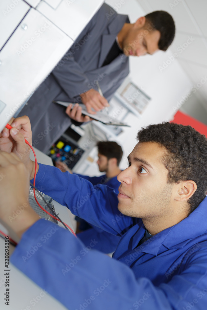 operator checking modern printing machine operator checking modern printing machine