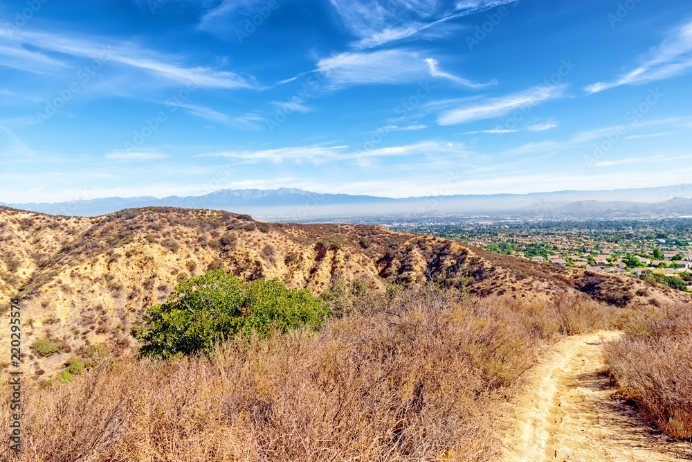 Mountain hiking trails above Southern California suburbs in the inland area on hot summer day