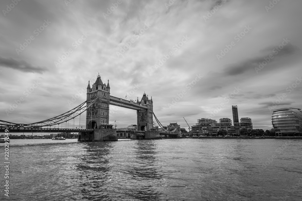 Wide-angle view of the Tower Bridge in London, UK in monochrome. Black and white photography.