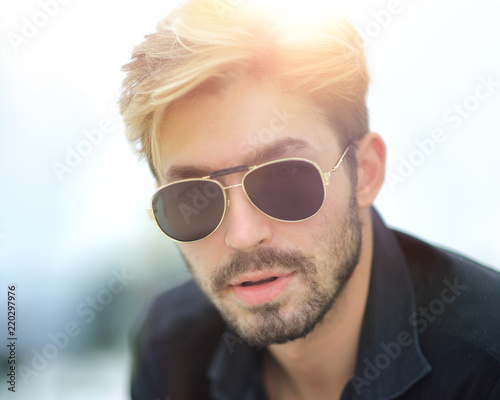 Businessman sitting in park using mobile phone