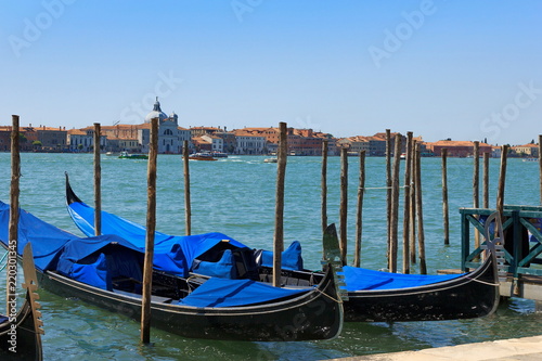 VENICE, ITALY - July 25 2018: Venetian gondolas on the water of the Canal Grande