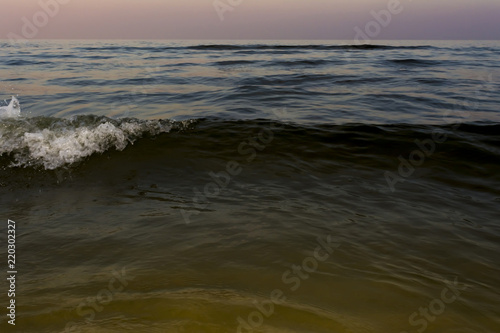 the night sea with waves and foam, sea sky after sunset time, nature abstract background