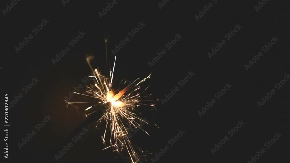 burning sparkler floating in the air on black background, hd footage burning sparkler floating in the air on black background, hd footage