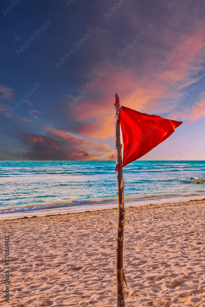 Red Warning Flag on Beach