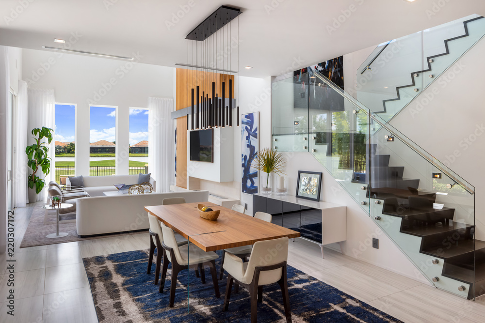 modern white open plan living and dining room with glass staircase ...