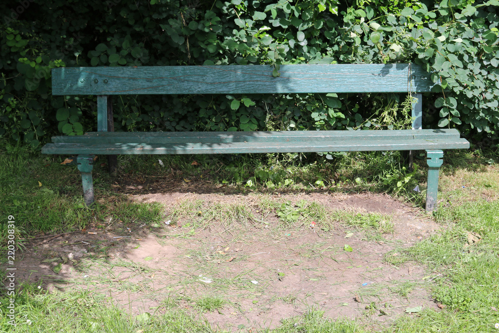 Park seat in a shady corner Park seat in a shady corner