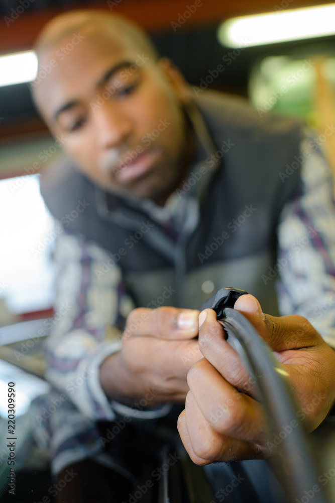 attentive technician fixing cable in server room