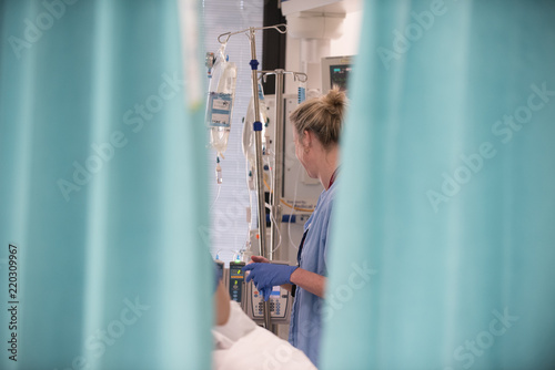 A nurse attends to a patient in the Intensive Care Unit