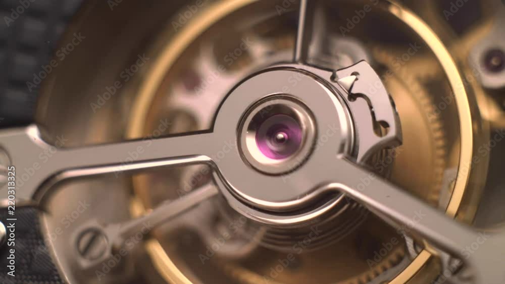 Mechanism of a watch with jewels. Open clockwork and fragments of shiny gears. Close up 4k macro shot. Time and work concept. Mechanism of a watch with jewels. Open clockwork and fragments of shiny gears. Close up 4k macro shot. Time and work concept.