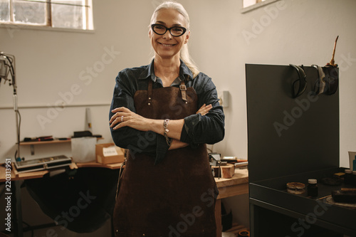 Portrait of confident senior female jeweler photo