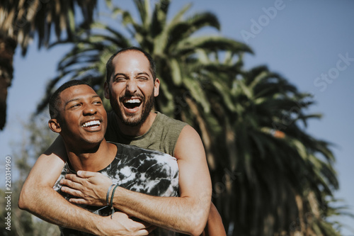 Gay couple hugging in the park photo