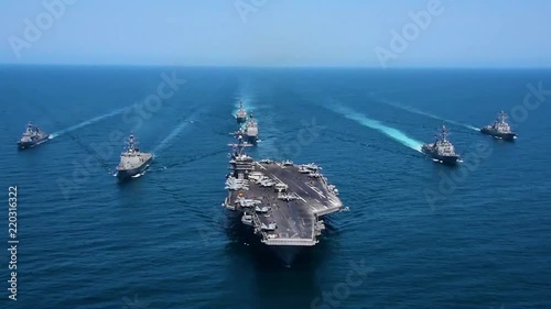 Very good aerial over a fleet of Amercian warships at sea.