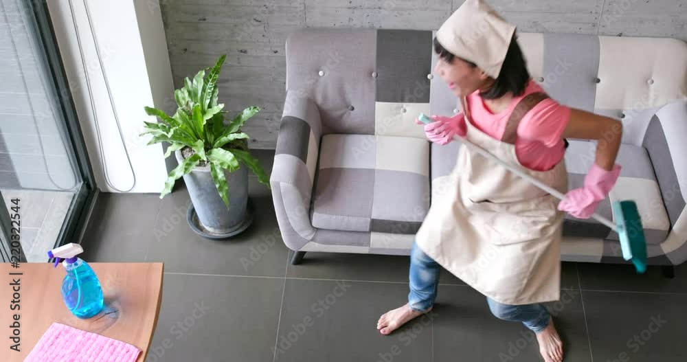 Excited woman dancing and holding brush and sing a song at home