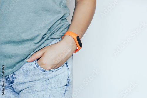 Girl is holding her hand in her jeans pocket photo