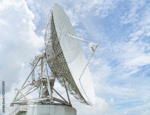 Fototapeta Naklejka Na Ścianę i Meble -  large white satellite dish turn up skyward on blue sky in earth communication antenna system center station