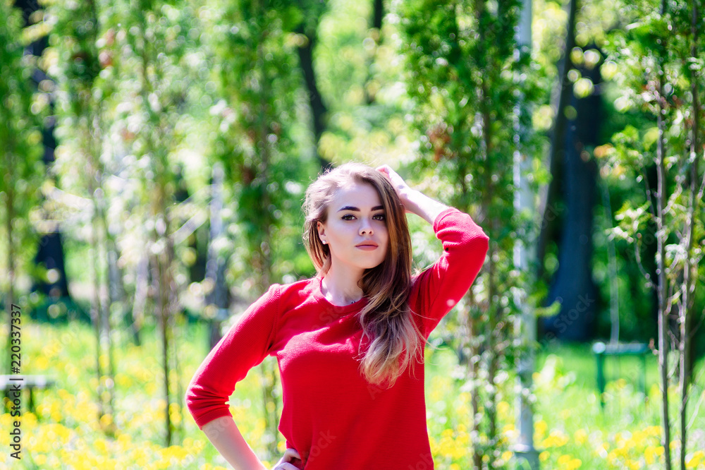 The girl is walking the park. Red jacket. The girl is walking the park. Red jacket.