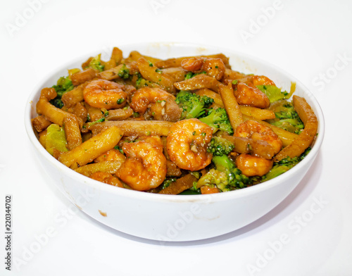 Shrimp with broccoli and sliced potatoes are deliciously seasoned in a white bowl on this special porcelain dish, this image is good for eastern restaurants, snack bars .