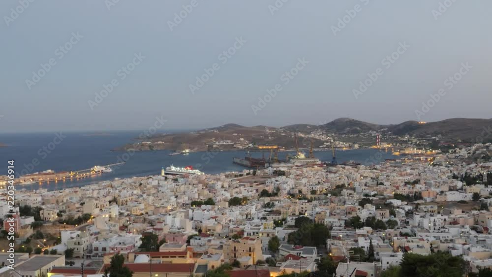 Landscape view of a village on the coast of Syros island in the Cyclades in the evening with city lights Landscape view of a village on the coast of Syros island in the Cyclades in the evening with city lights
