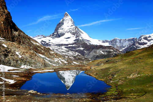 The reflection of the Matterhorn on the surface of the Riffelsee lake is one of the most popular photo spot in Zermatt, Switzerland.