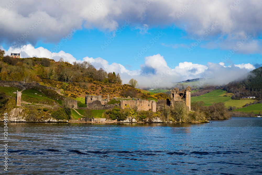 Urquhart Castle as seen from Loch Ness lake in the Highlands of Scotland Urquhart Castle as seen from Loch Ness lake in the Highlands of Scotland