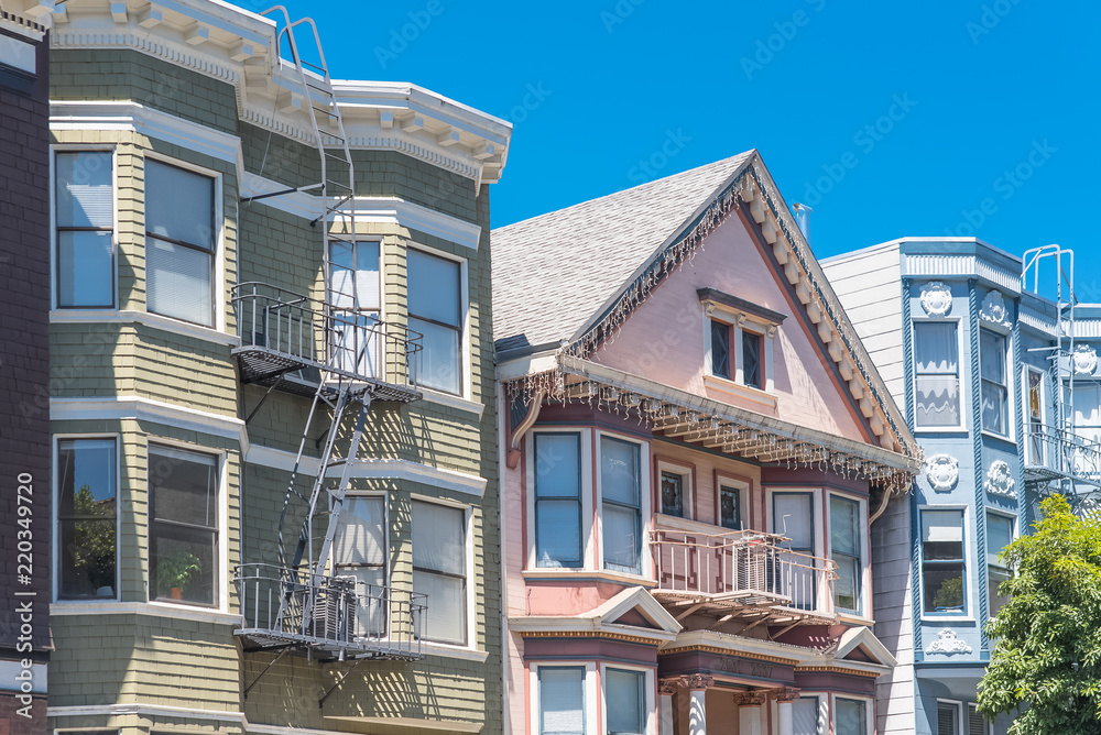 San Francisco, typical colorful houses with fire escape staircases outdoors
