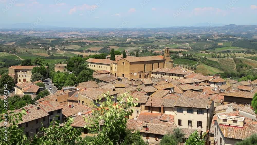 View of the medieval Italian village of San Gimignano at noon.