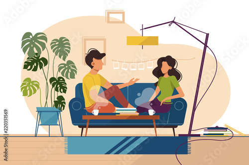 Couple of guy and girl sitting on couch at home