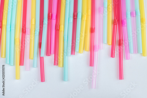 blue  pink and yellow straws for cocktails and other drinks isolated on white background