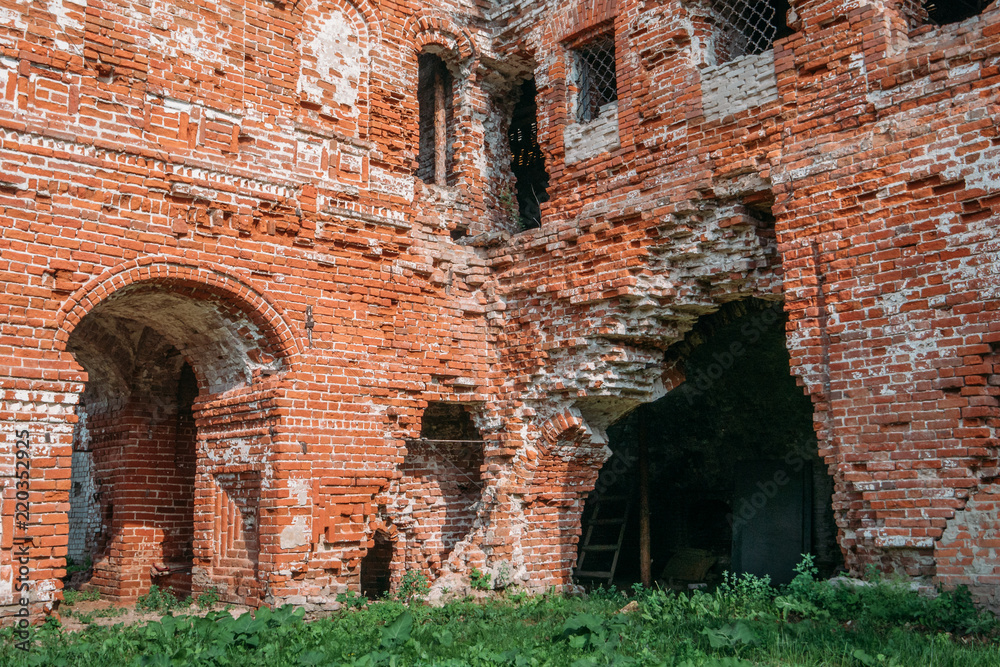 Old ruins of a medieval abandoned ruined red brick castle or Orthodox temple
