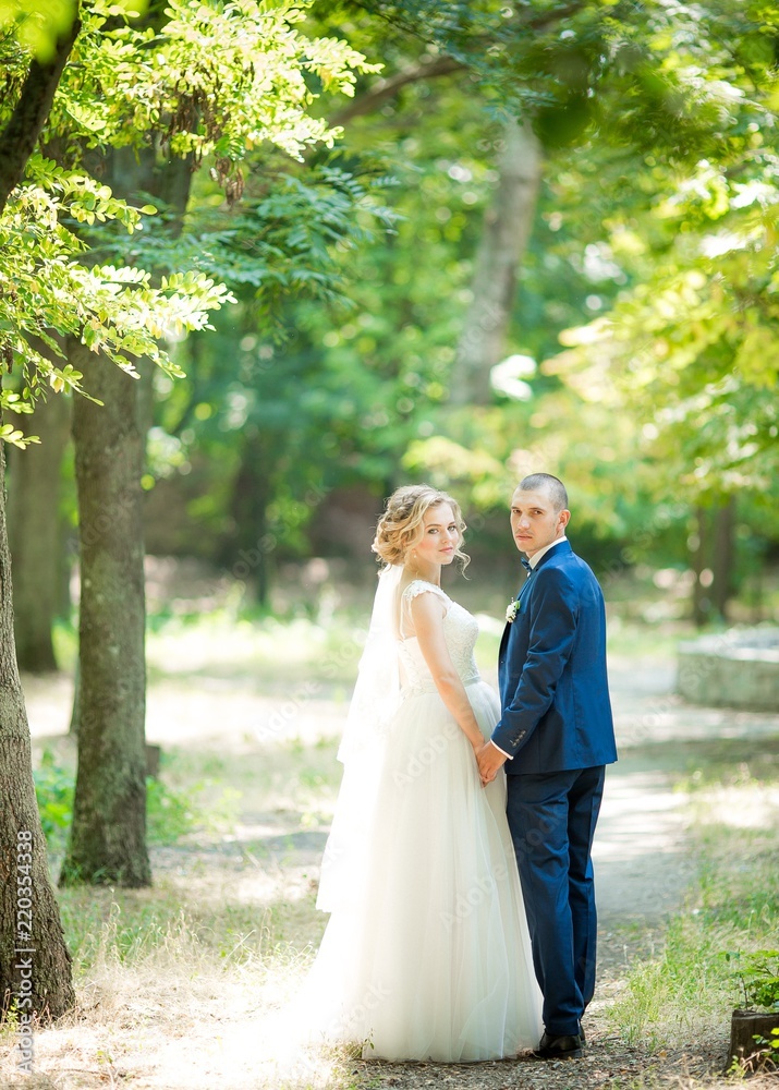 Happy bride and groom on their wedding in summer garden Happy bride and groom on their wedding in summer garden