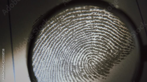 A police officer investigate fingerprints. Macro shot.
