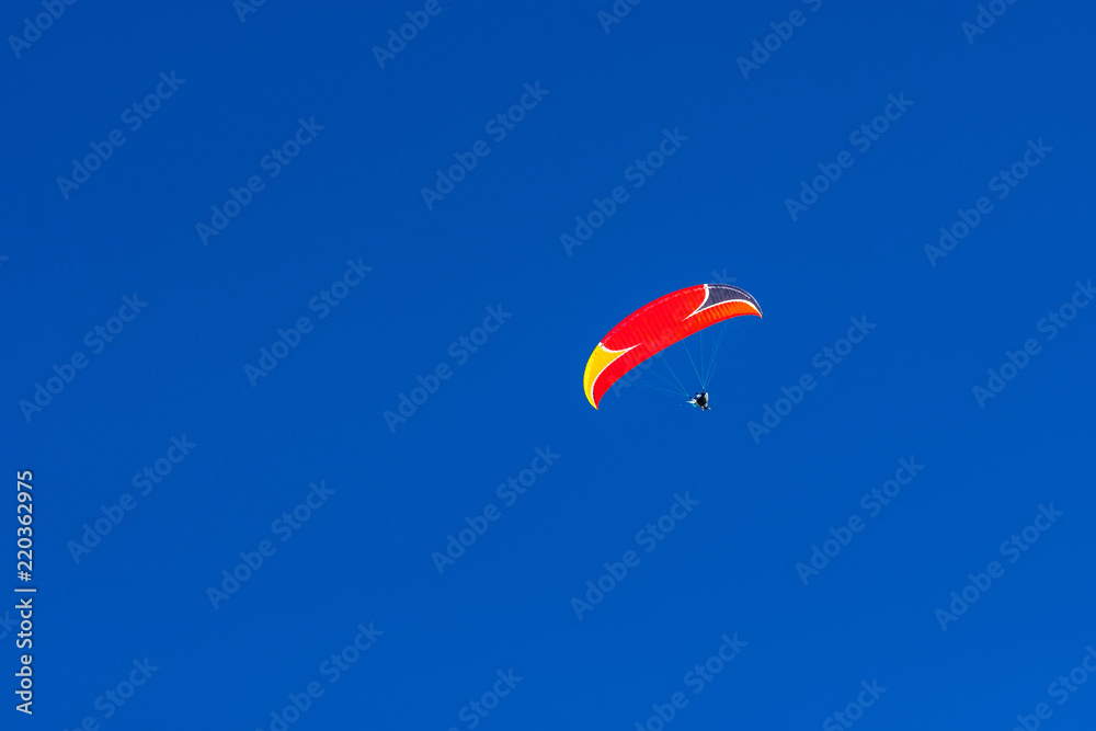 Flying paraglider in the blue sky Flying paraglider in the blue sky