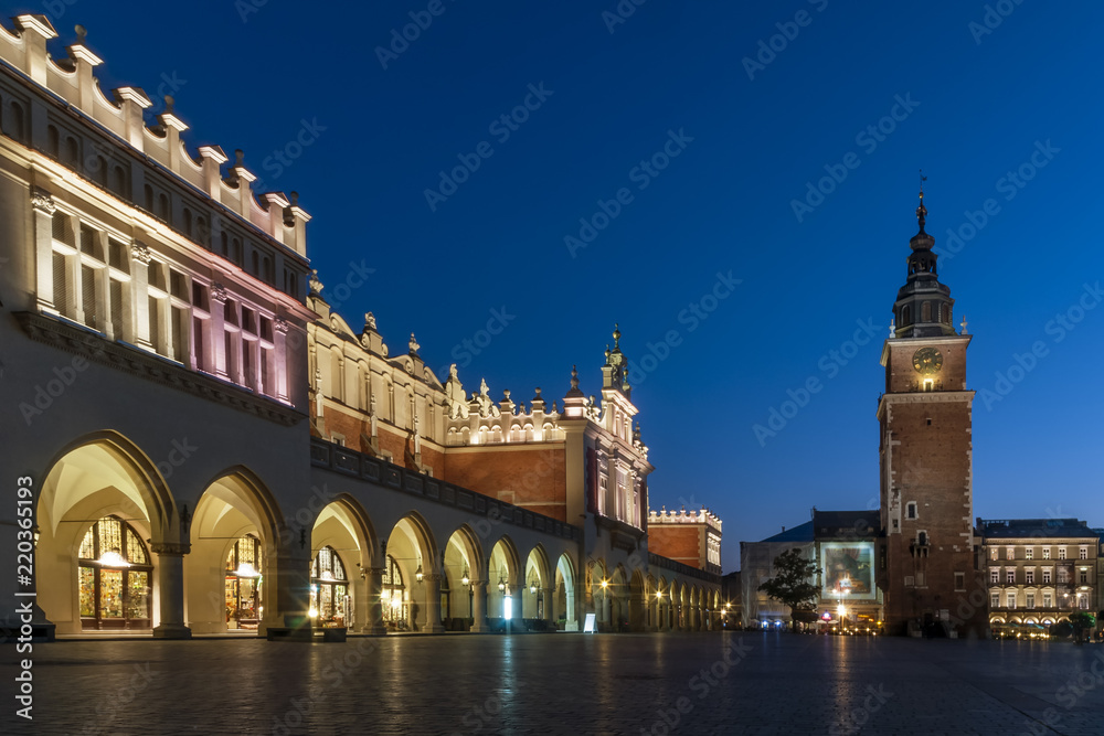 Beautiful view of Cloth Hall (Sukiennice) and Tower Hall (Wieża ratuszowa w Krakowie) in the blue hour, Krakow's Old Town, Poland, main market square