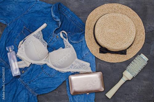 Personal things girl: straw hat, denim dress, bra, hairbrush and perfume  photo