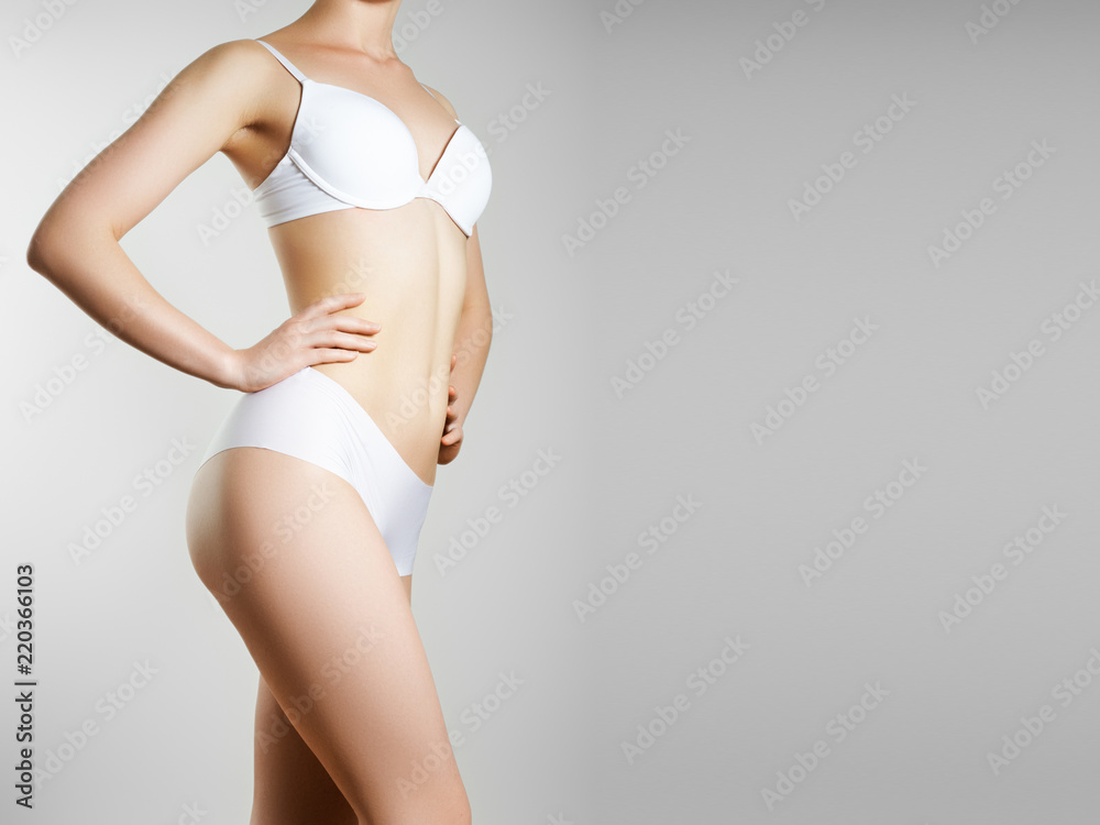 Perfect slim toned young body of the girl. An example of sports , fitness or plastic surgery and aesthetic cosmetology