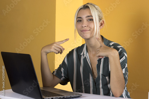 Proud businesswoman pointing to herself in the office photo