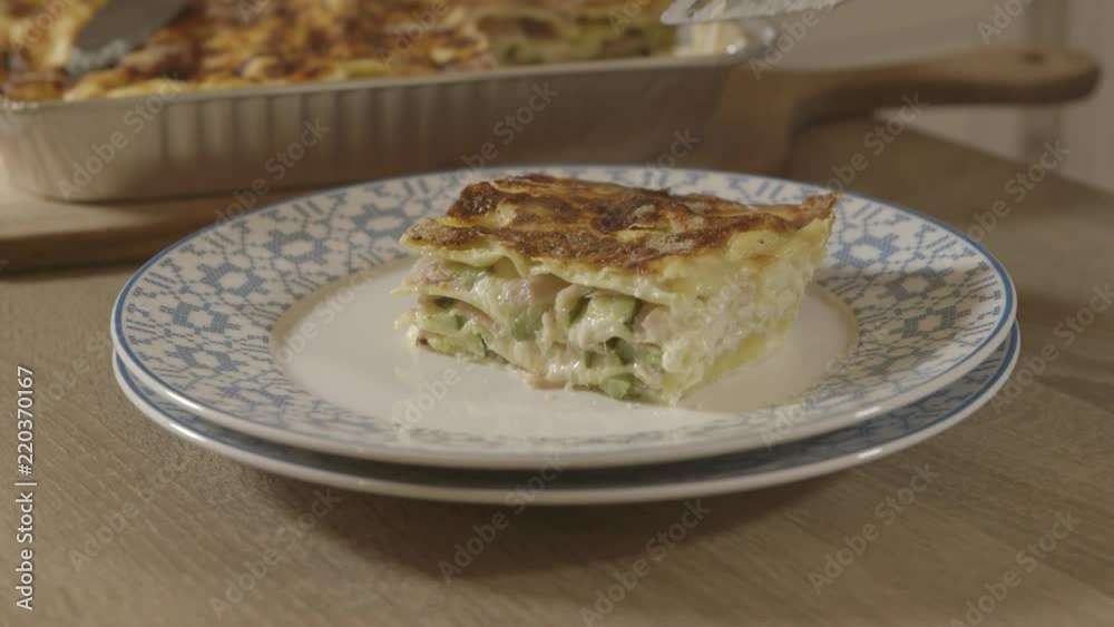 Plating a portion of a traditional Italian Ham and Zucchini lasagne. Plating a portion of a traditional Italian Ham and Zucchini lasagne.
