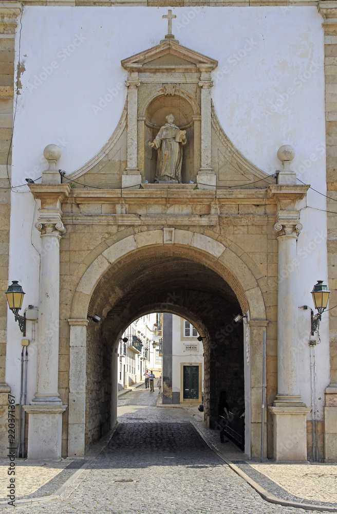 arch entrance to the old town of city Faro