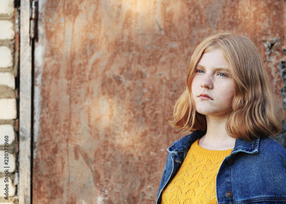 Fototapeta premium sad teenager girl on background brown wall
