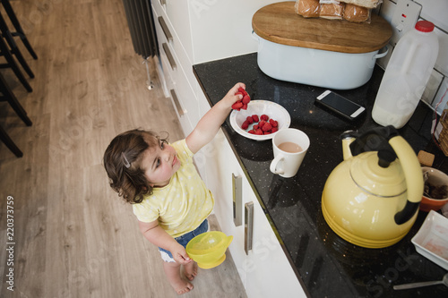 Little Girl Reaching for Fruit photo