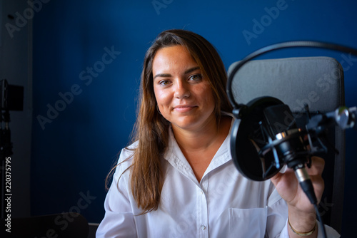mujer grabando un podcast en un estudio
