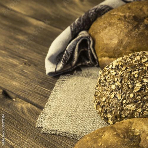 Rustic still life. Food. Assortment of fresh baked bread in the bakery on the background of a wooden table © Светлана Евграфова
