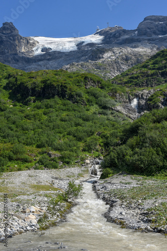 River with water from the glacier of mount Titlis over Engelberg on Switzerland