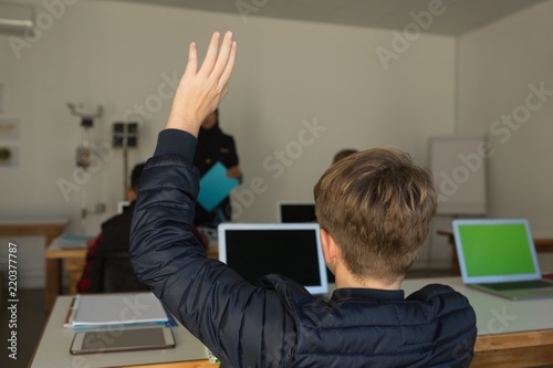 Student  raising hand for asking query photo